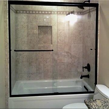 Black framed sliding glass door for tub/shower combo installed by Great Lakes Glass in Cleveland, Ohio